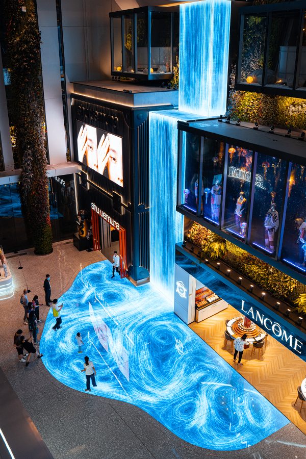 Mallgoers interacting with a Teamlab exhibition imitating flowing water inside Zhongzhou Bay C Future City. 